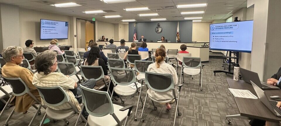 A seated audience gathers for the hybrid pre-rulemaking stakeholder session inside the CCAP meeting room in Sacramento, California.