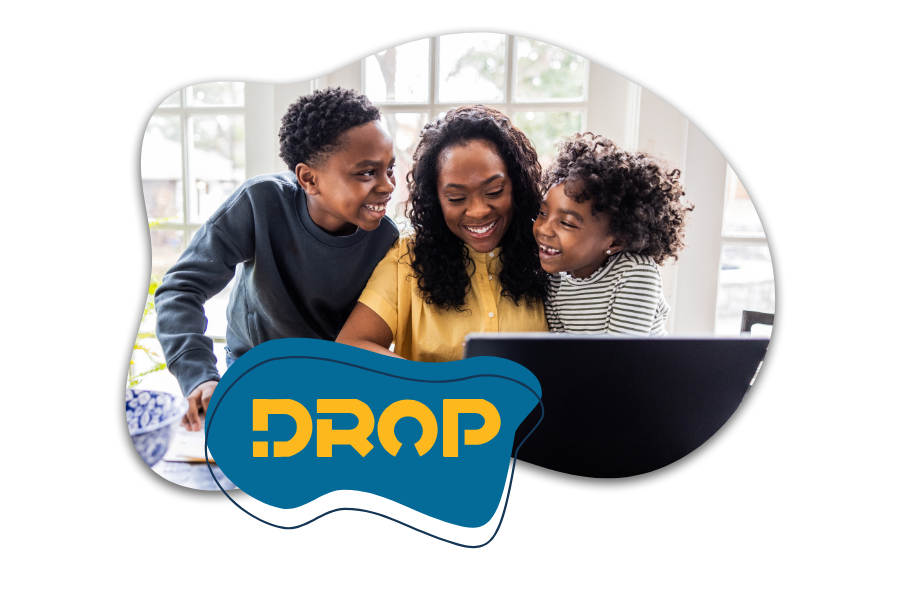 A smiling mother with dark brown skin types on a laptop as her young son and daughter stand next to her and smile. DROP logo in yellow on a blue background